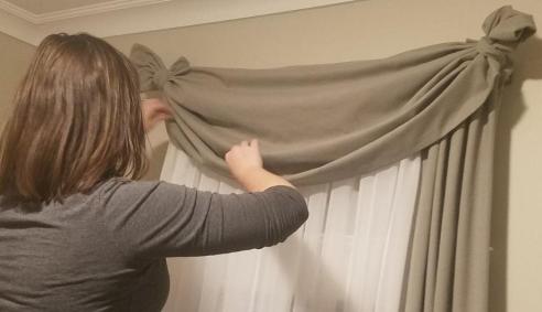 Em adjusts skinny swag